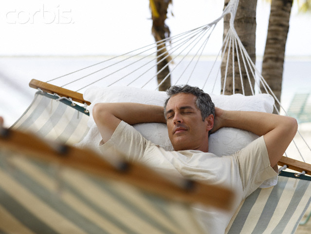Man Relaxing in Hammock on Beach
