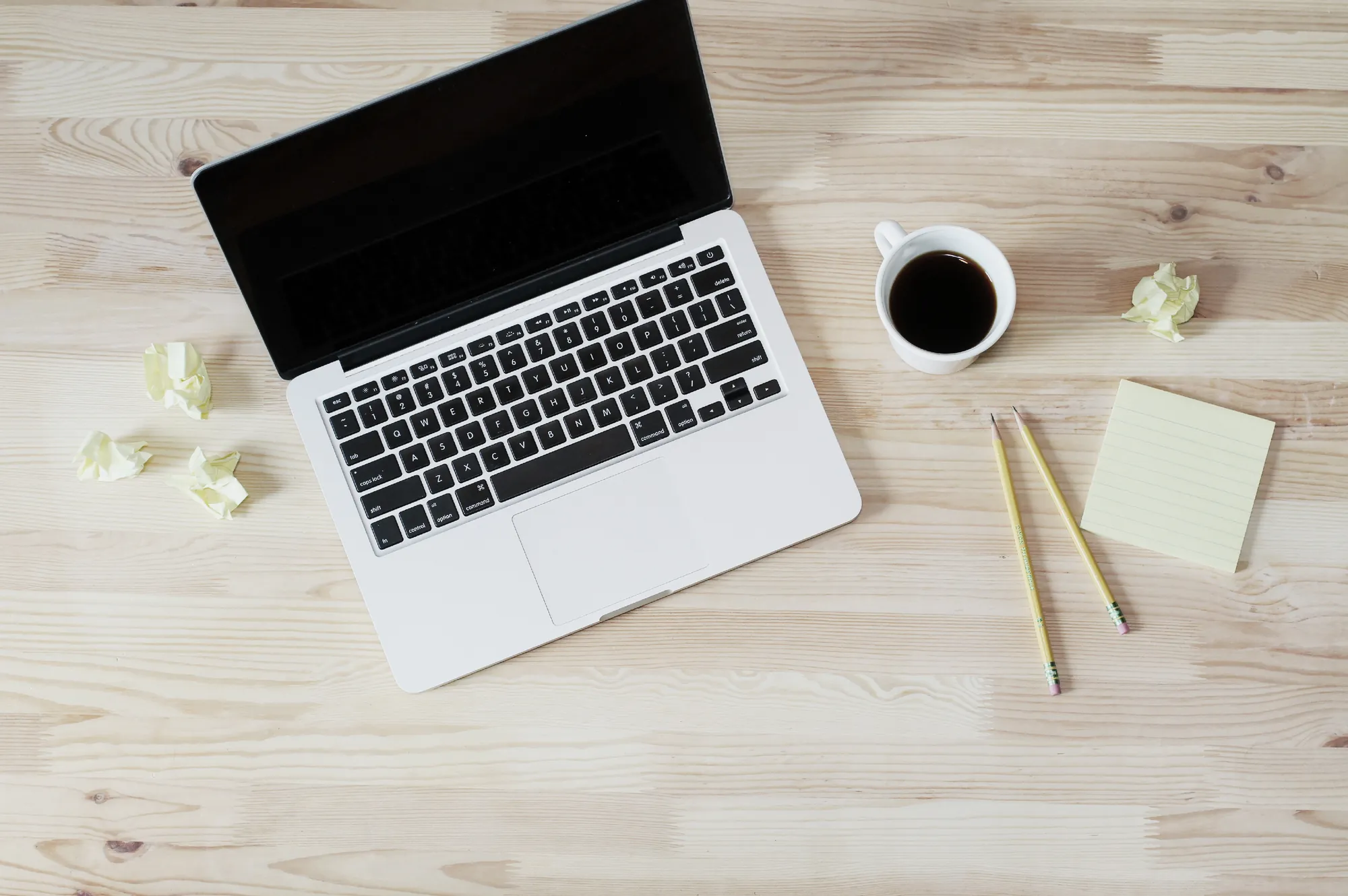 A view of a desk with a computer and a cup of coffee on it